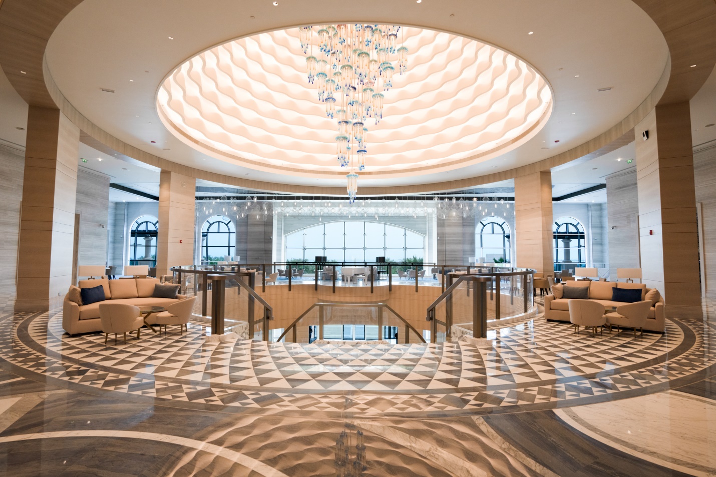 A large room with a chandelier and a large ceiling

Description automatically generated