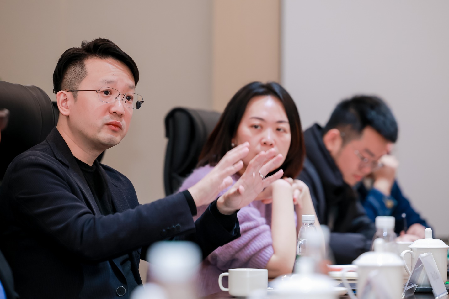 A group of people sitting at a table

Description automatically generated