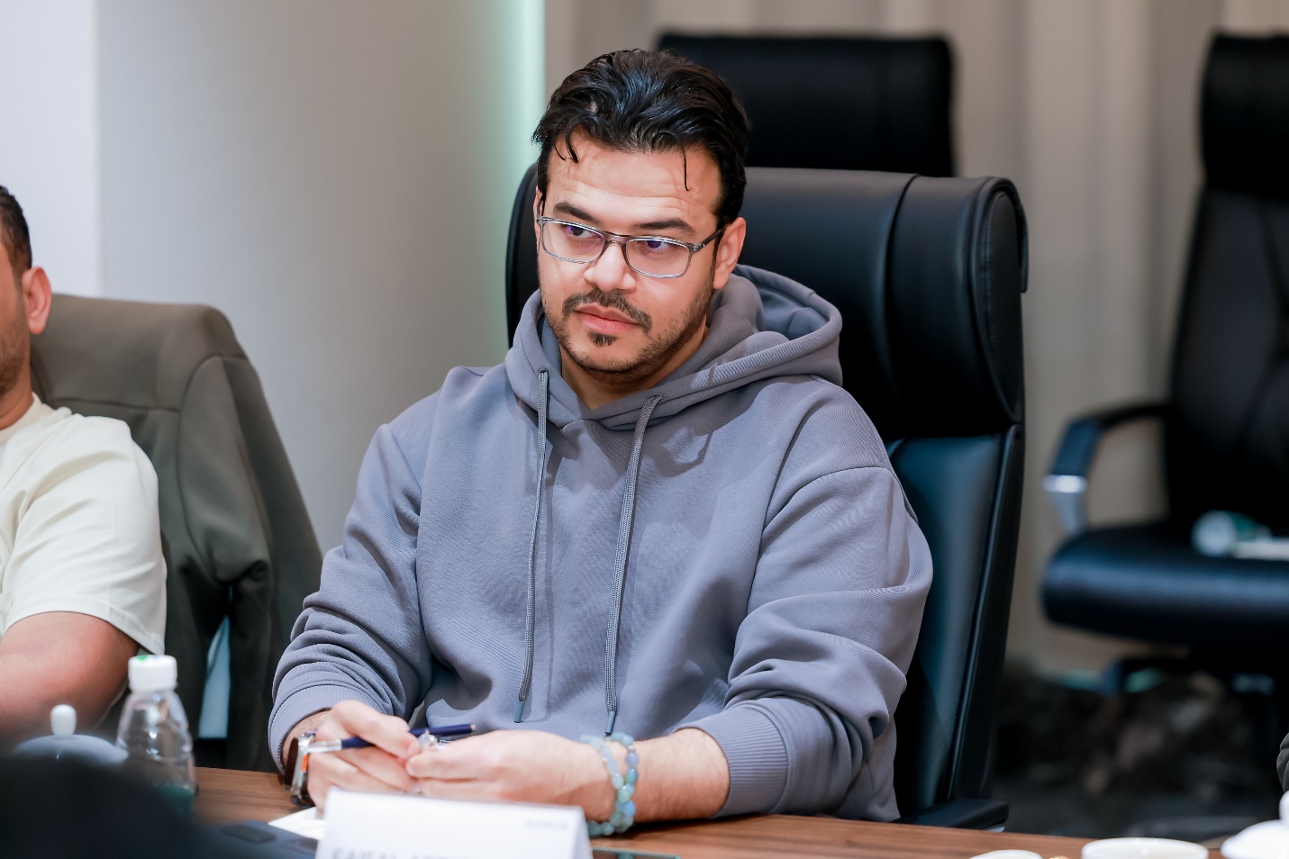 A person sitting at a desk

Description automatically generated